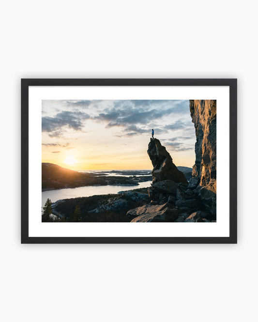 Framed print of Adam Ondra on top of the spire in Flatanger, Norway.