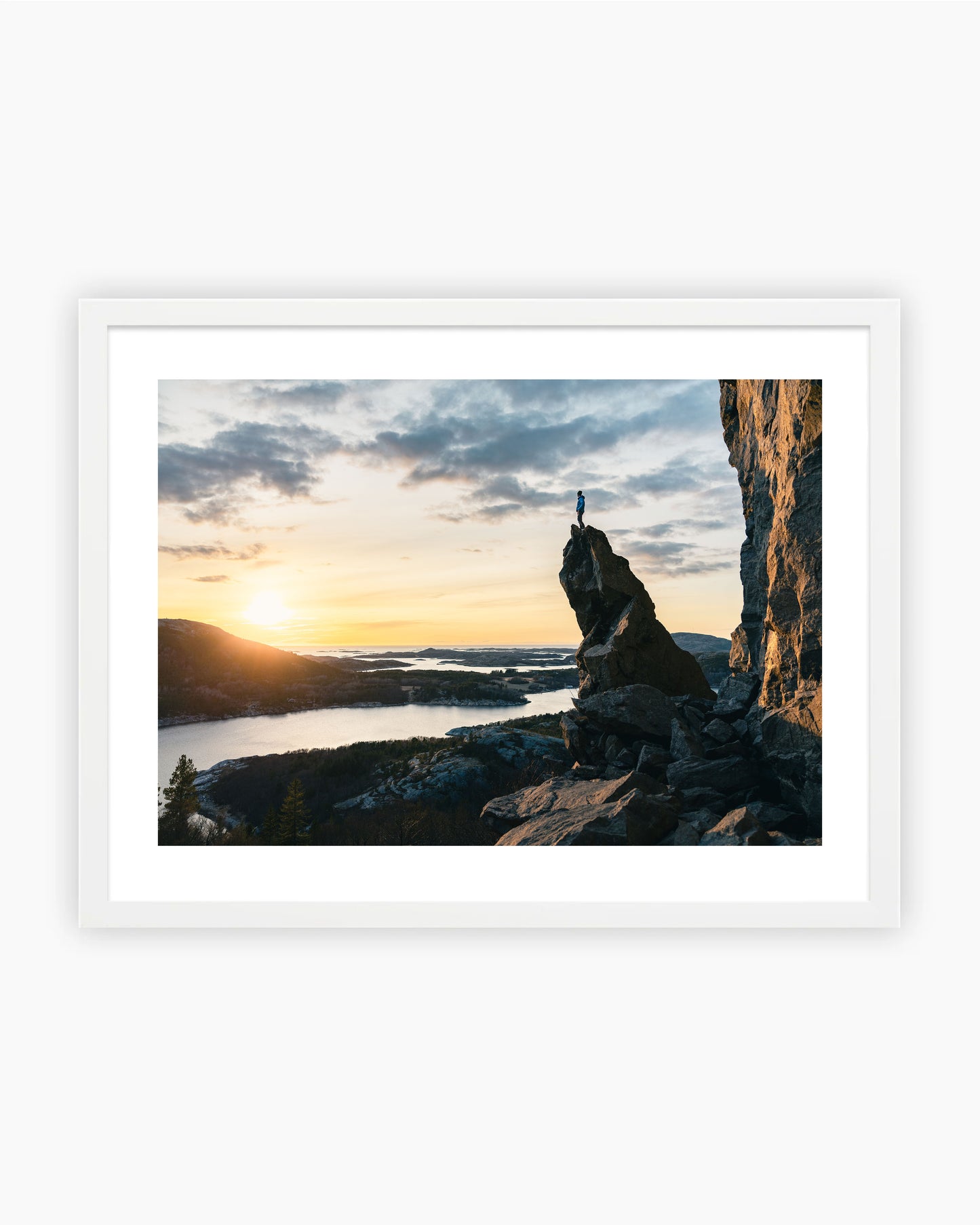 Framed print of Adam Ondra on top of the spire in Flatanger, Norway.