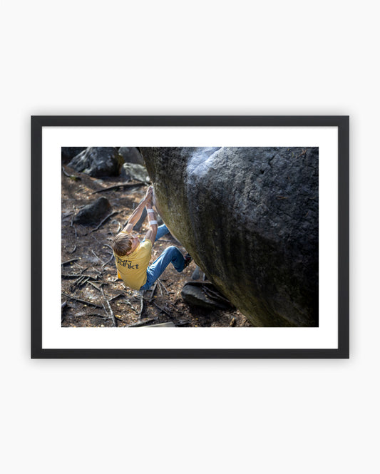 Framed print of Alex Megos climbing Karma 8A+ in Fontainebleau, France.