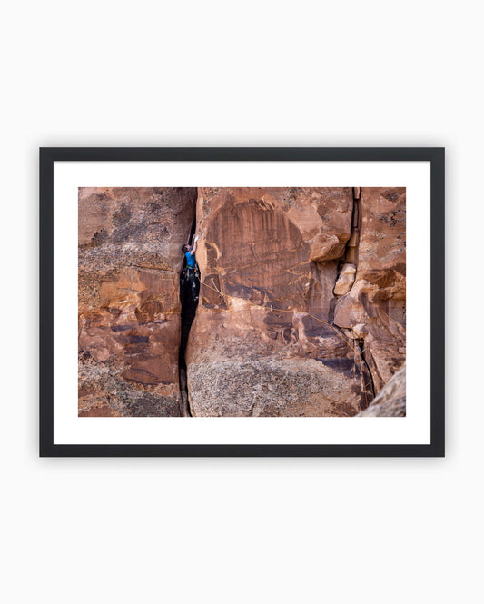 Framed print of Ben Rueck climbing Fast Draw 5.10+ on Sentinel Spire in Colorado National Monument, USA.