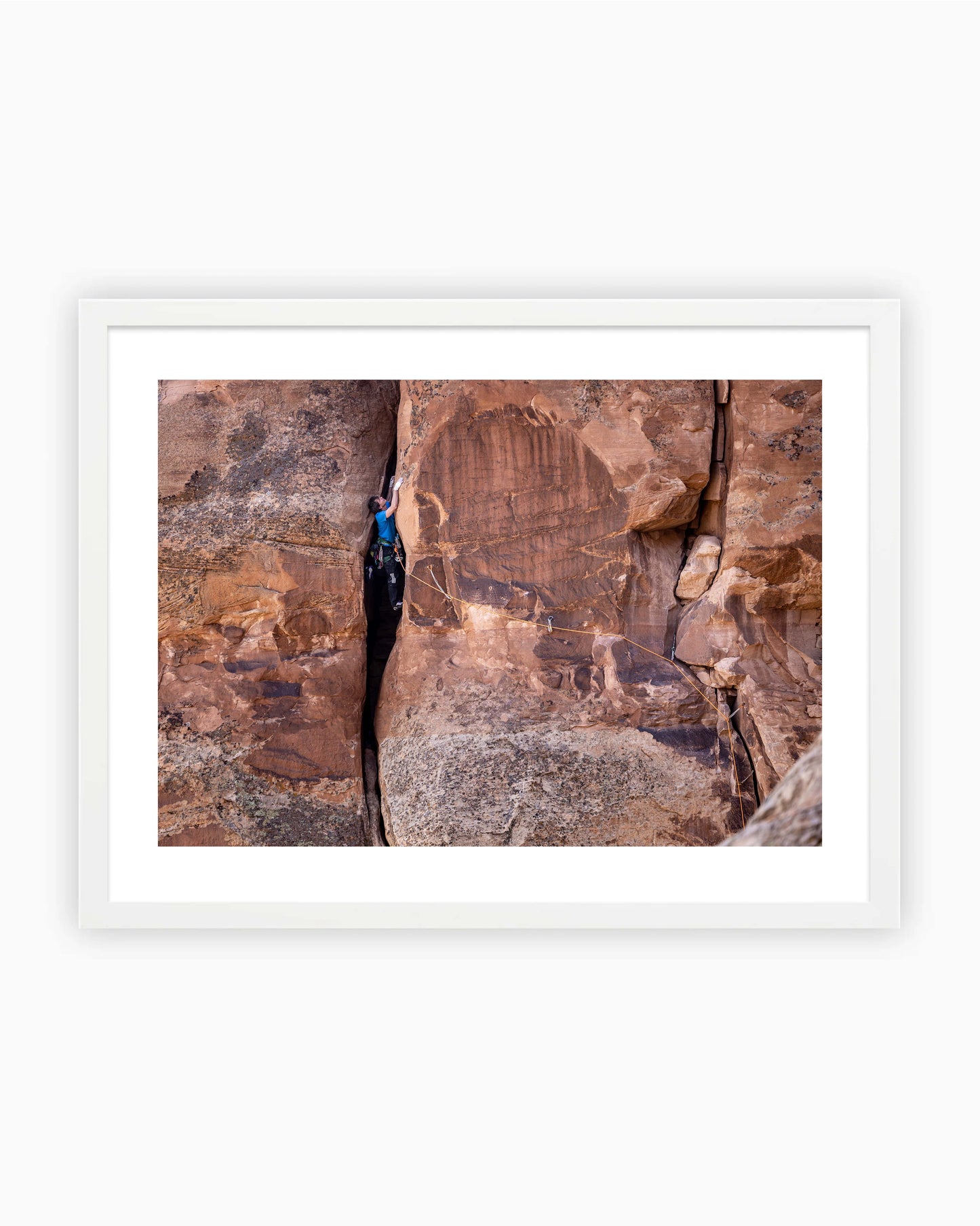 Framed print of Ben Rueck climbing Fast Draw 5.10+ on Sentinel Spire in Colorado National Monument, USA.
